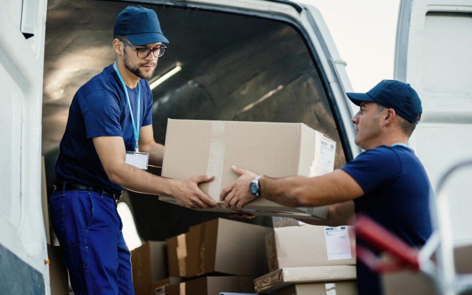 delivery-men-loading-carboard-boxes-van-while-getting-ready-shipment