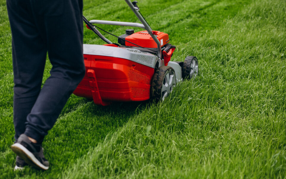 man-cutting-grass-with-lawn-mover-back-yard